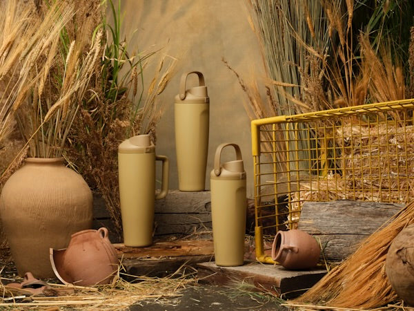 Autumn Vista bottles grouped among wheat, pottery, and warm seasonal decor