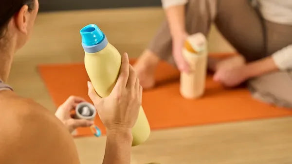 A person holding a yellow FreeSip Twist